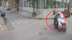 Câmeras de segurança registraram o momento em que criminosos se aproximaram do motociclista ferido para roubar seus objetos - Imagem: Reprodução