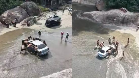 Banhistas se unem para ajudar motorista atolado na Praia do Perequê, enquanto maré ameaça o veículo - Foto: Drone Fox