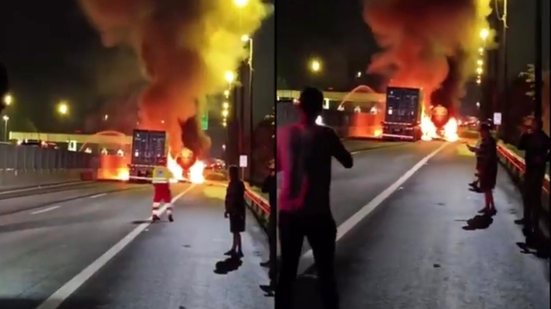 Carreta pega fogo após colisão traseira perto de pedágio rumo ao Guarujá; motoristas saem ilesos - Imagem: Reprodução / Guarujá Mil Grau