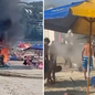 Banhistas utilizam areia para conter incêndio que destruiu carrinho de frutos do mar na praia da Enseada, em Guarujá. - Imagem: Reprodução