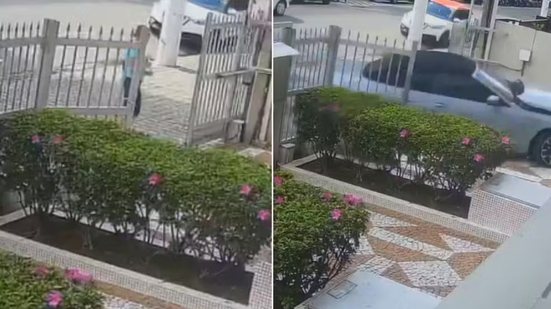 Câmera de monitoramento registrou o momento em que um carro invadiu a entrada de um condomínio no bairro Gonzaga, em Santos, causando danos à estrutura e colocando uma pedestre em situação de risco - Imagem: Reprodução