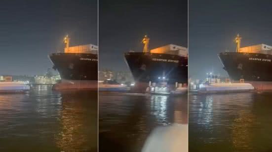 Momento em que o porta-contêineres Seaspan Empire se aproxima da balsa durante manobra noturna no Porto de Santos; colisão ocorreu minutos depois e mobilizou equipes de resgate - Imagem: Redes Sociais