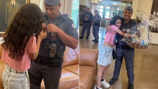 Menina de 10 anos entrega carta e presente ao cabo Willian Alves Dias durante reencontro realizado na sexta-feira (16), na sede do comando da Polícia Militar, em São Paulo - Imagem: Arquivo Pessoal