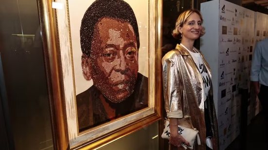 A artista sérvia Milena ZeVu apresenta retrato de Pelé produzido com mais de 17 mil cristais Swarovski durante cerimônia realizada no Museu Pelé, em Santos, na quinta-feira (22) - Imagem: Alexsander Ferraz/A Tribuna Jornal